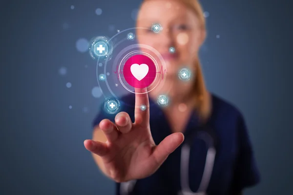 Young nurse pressing modern medical type of buttons — Stock Photo, Image