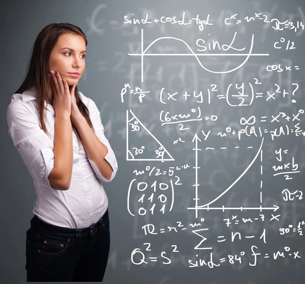 Beautiful school girl thinking about complex mathematical signs — Stock Photo, Image