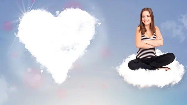 Beautiful lovely woman sitting on cloud with heart — Stock Photo, Image