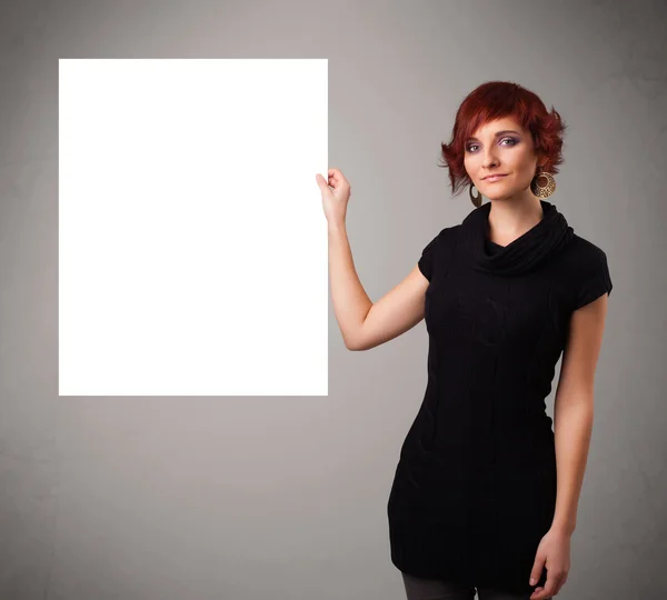 Young woman presenting white paper copy space — Stock Photo, Image