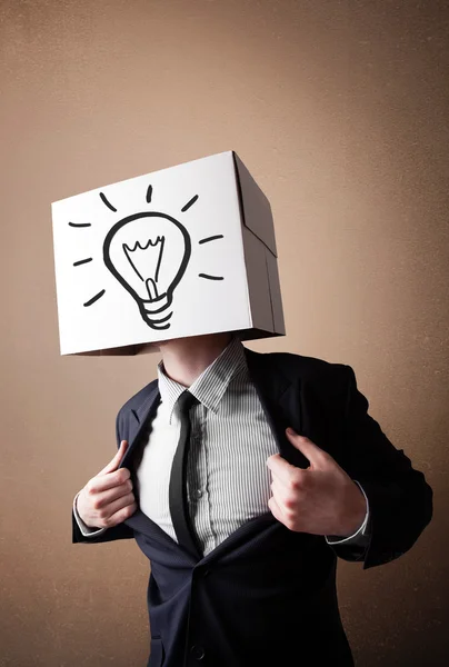 Businessman gesturing with a cardboard box on his head with ligh — Stock Photo, Image