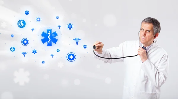 Doctor with blue medical icons — Stock Photo, Image