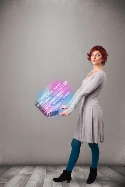 Casual woman holding laptop with exploding data and numers — Stock Photo, Image