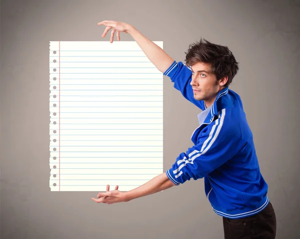 Young man holding white paper copy space with diagonal lines — Stock Photo, Image