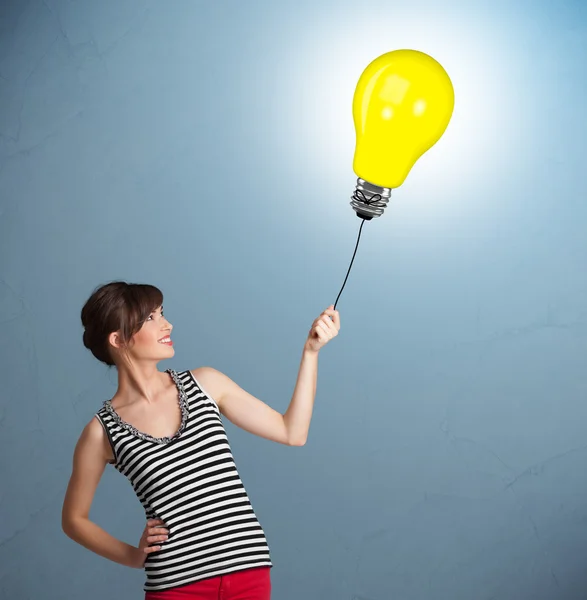 Pretty lady holding a light bulb balloon — Stock Photo, Image