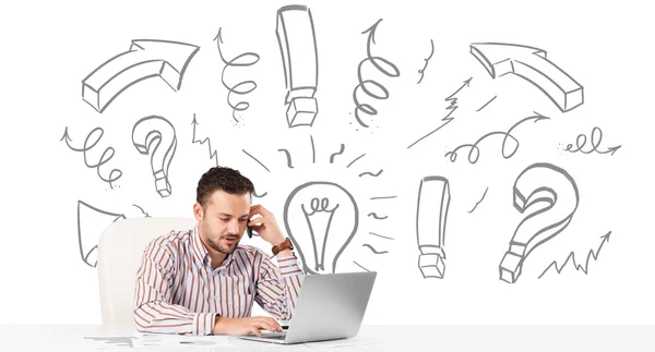 Young businessman brainstorming with drawn arrows and symbols — Stock Photo, Image