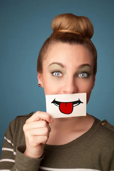 Happy pretty woman holding card with funny smiley — Stock Photo, Image