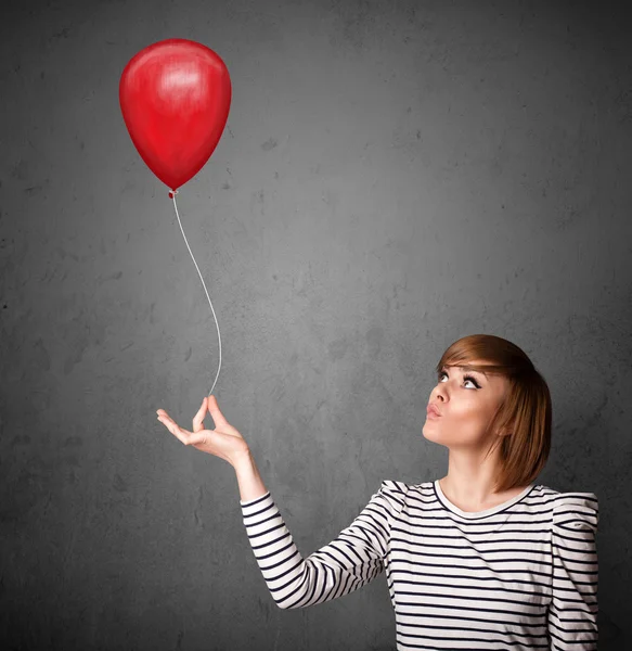 Mulher segurando um balão vermelho — Fotografia de Stock