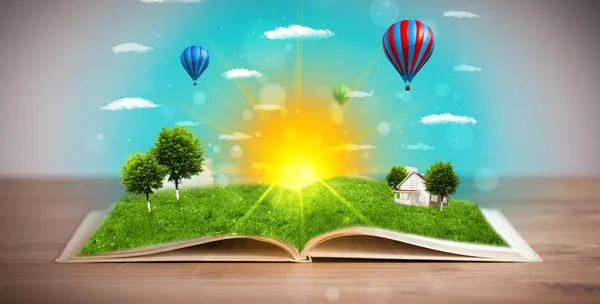 Open book with green nature world coming out of its pages — Stock Photo, Image