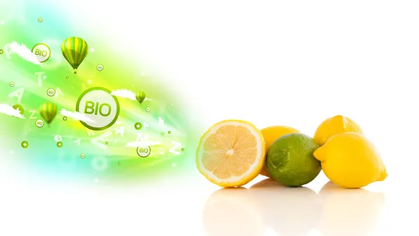 Colorful juicy fruits with green eco signs and icons — Stock Photo, Image