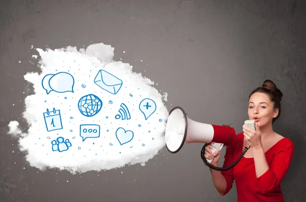 Woman shouting into loudspeaker and modern blue icons and symbol — Stock Photo, Image