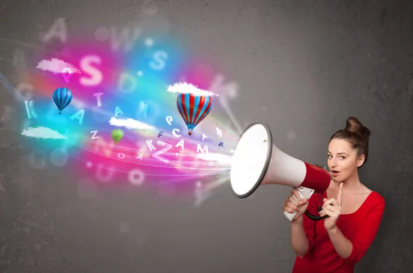 Girl shouting into megaphone and abstract text and balloons come — Stock Photo, Image