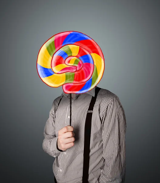 Businessman holding a lollipop — Stock Photo, Image