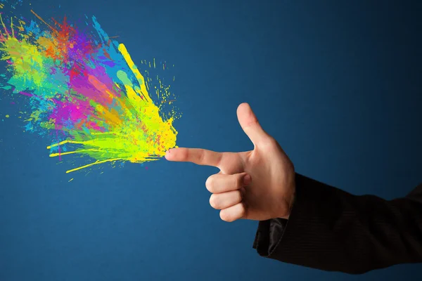 Colorful splashes are coming out of gun shaped hands — Stock Photo, Image