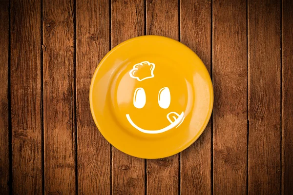 Happy smiley cartoon face on colorful dish plate — Stock Photo, Image