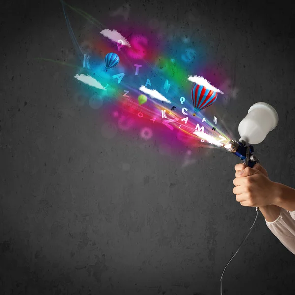 Worker with airbrush and colorful abstract clouds and balloons — Stock Image Worker with airbrush and colorful abstract clouds and balloons Stock Photo