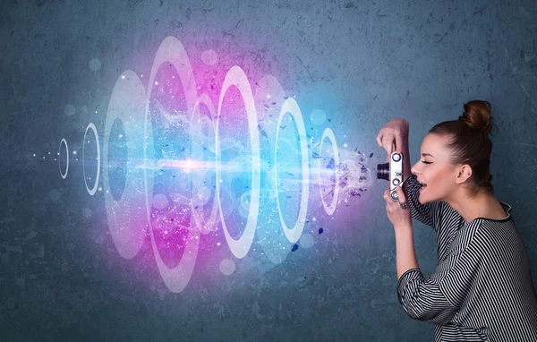 Photographer girl making photos with powerful light beam — Stock Photo, Image