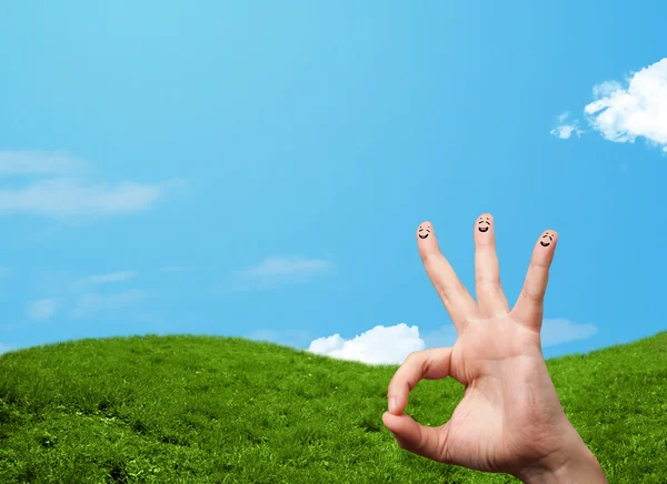 Cheerful finger smileys with landscape scenery at the background — Stock Photo, Image