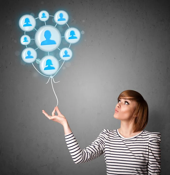 Woman holding social network balloon — Stock Photo, Image