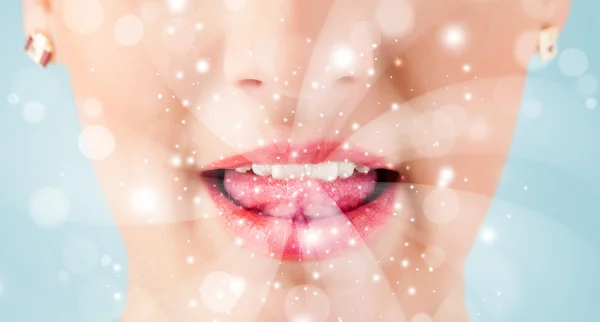 Jolie femme lèvres soufflant des lumières blanches abstraites — Photo