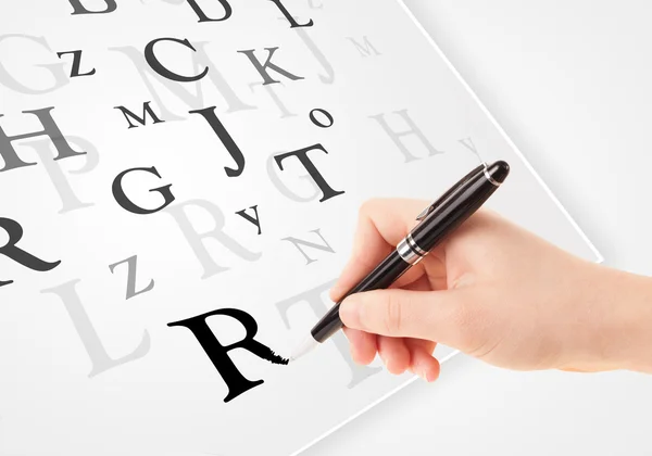 Hand writing various letters on white plain paper