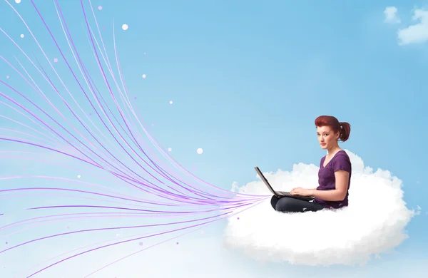 Young woman sitting in cloud with laptop — Stock Photo, Image