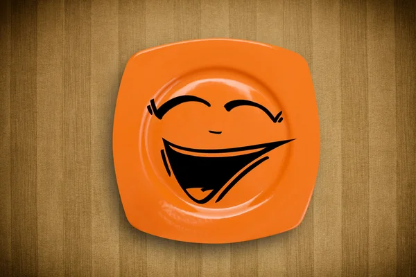 Happy smiley cartoon face on colorful dish plate — Stock Photo, Image