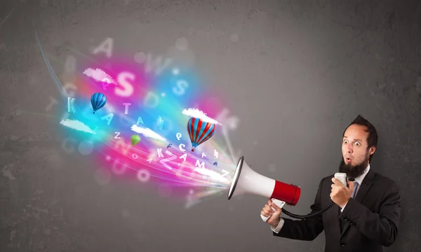 Man shouting into megaphone and abstract text and balloons come — Stock Photo, Image