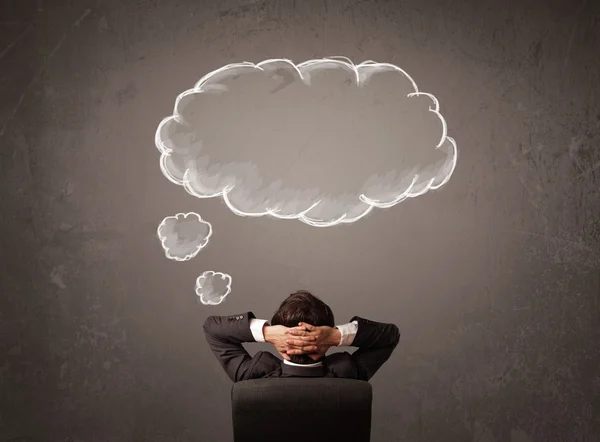 Businessman sitting with cloud thought above his head — Stock Photo, Image