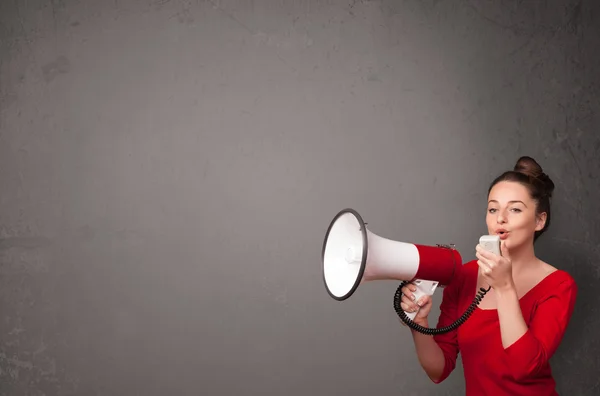 Girl shouting into megaphone on copy space background — Stock Photo, Image