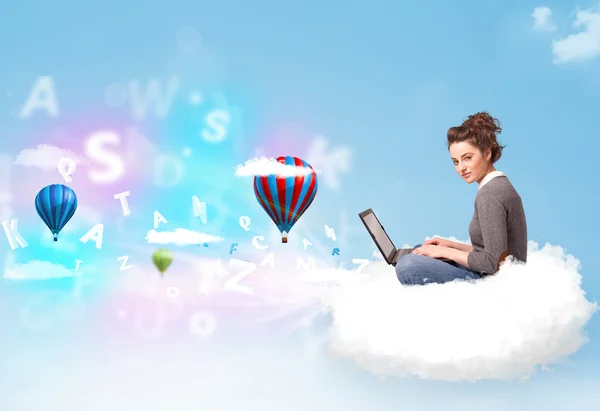 Young woman sitting in cloud with laptop — Stock Photo, Image