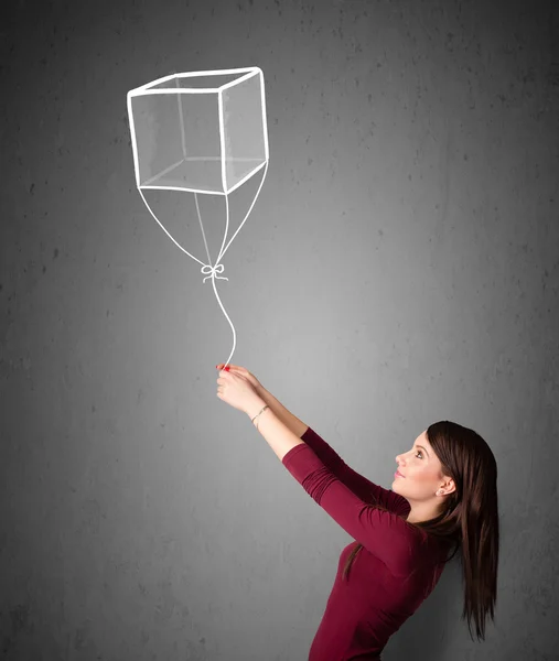 Donna in possesso di un palloncino cubo — Foto Stock