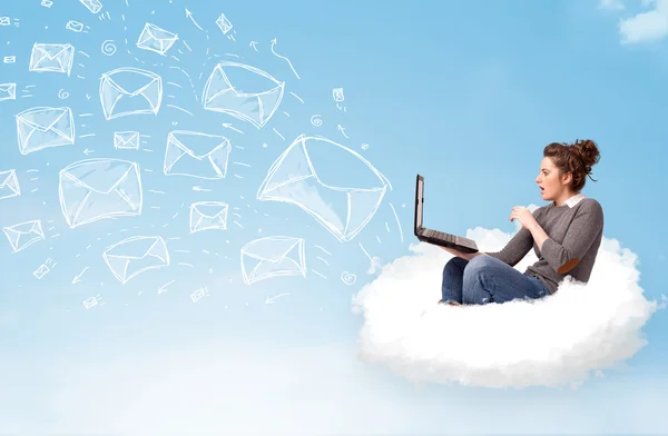 Young woman sitting in cloud with laptop — Stock Photo, Image