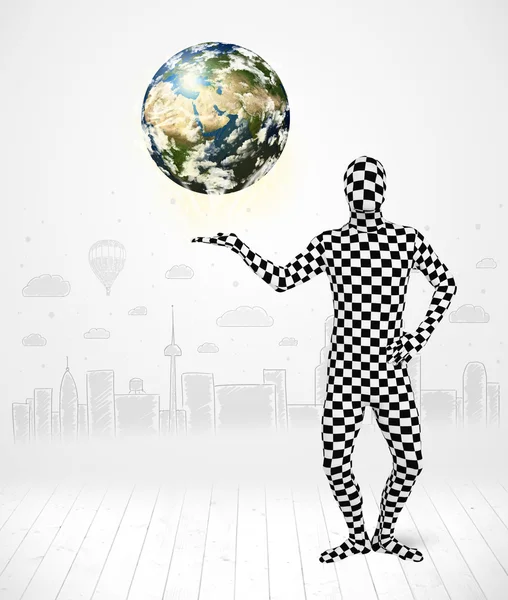 Man in full body suit holding planet earth — Stock Photo, Image