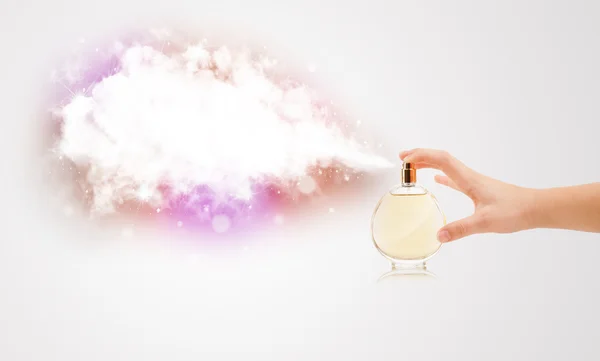 Woman hands spraying colorful cloud — Stock Photo, Image