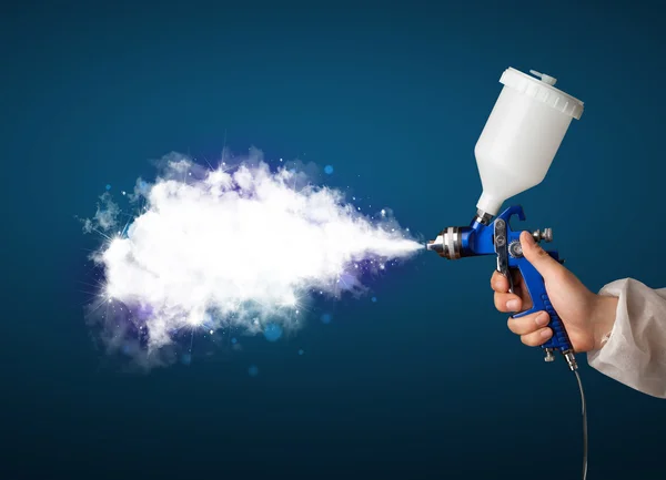 Painter with airbrush gun and white magical smoke — Stock Photo, Image