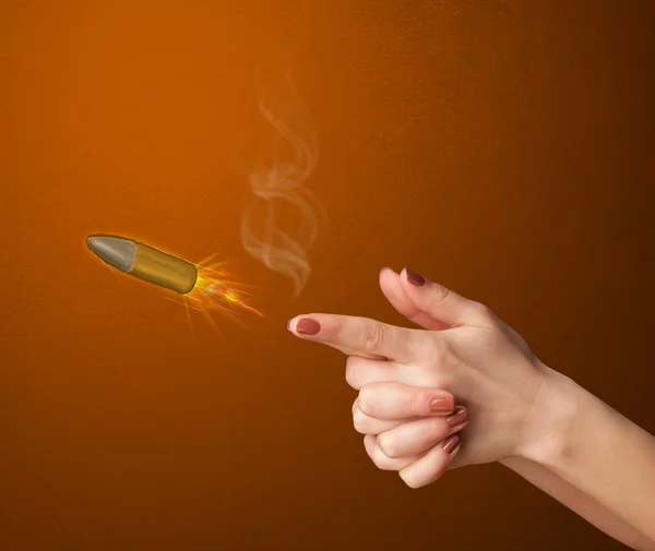 Gun shaped woman hand with bullet — Stock Photo, Image