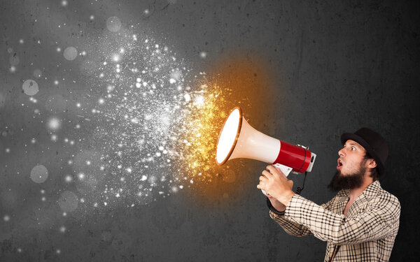 Guy shouting into megaphone and glowing energy particles explode