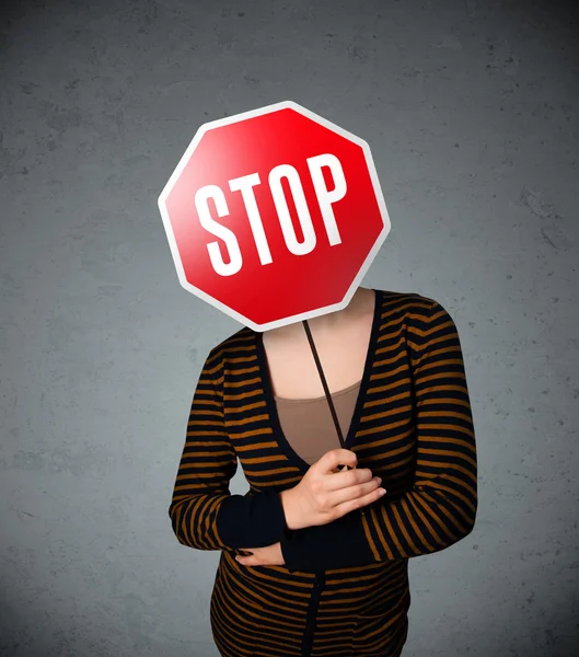 Young woman holding a stop sign — Stock Photo, Image