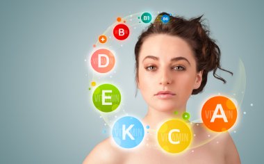 Pretty young girl with colorful vitamin icons and symbols clipart