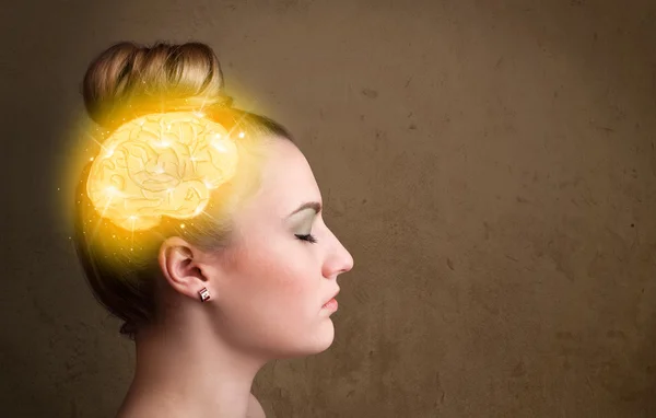 Young girl thinking with glowing brain illustration — Stock Photo, Image