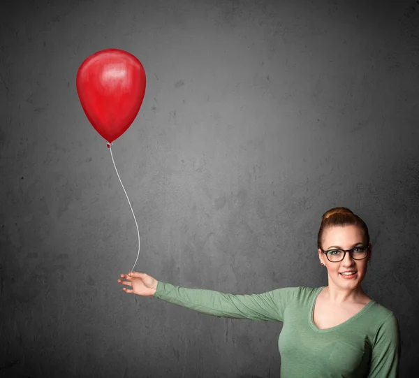 Mulher segurando um balão vermelho — Fotografia de Stock