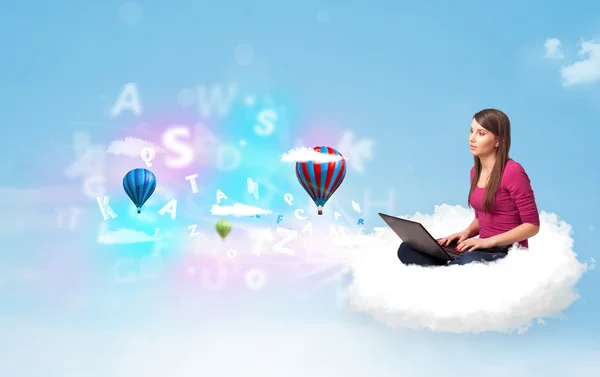 Young woman sitting in cloud with laptop — Stock Photo, Image