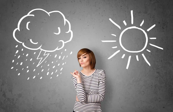 Woman standing between a sun and a rain drawing — Stock Photo, Image