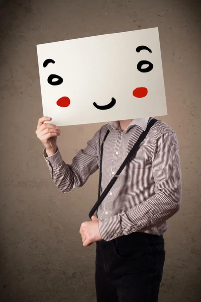 Obchodník držící karton s usměvavou tváří — Stock fotografie