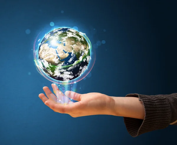 Woman holding a glowing earth globe — Stock Photo, Image