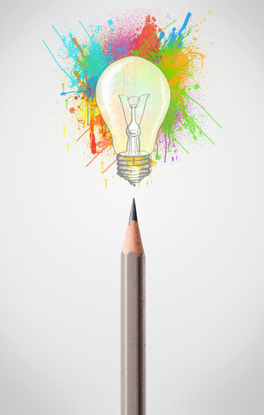 Pencil close-up with colored paint splashes and lightbulb