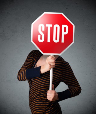 Elinde dur tabelası tutan genç bir kadın.