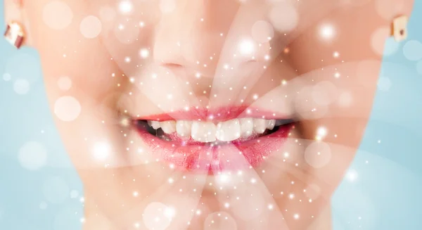 Pretty woman lips blowing abstract white lights — Stock Photo, Image