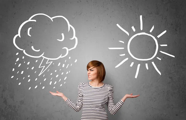 Woman standing between a sun and a rain drawing — Stock Photo, Image